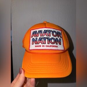 Aviator Nation Bright Orange Mesh Trucker Cap with Patriotic Patch - unisex
